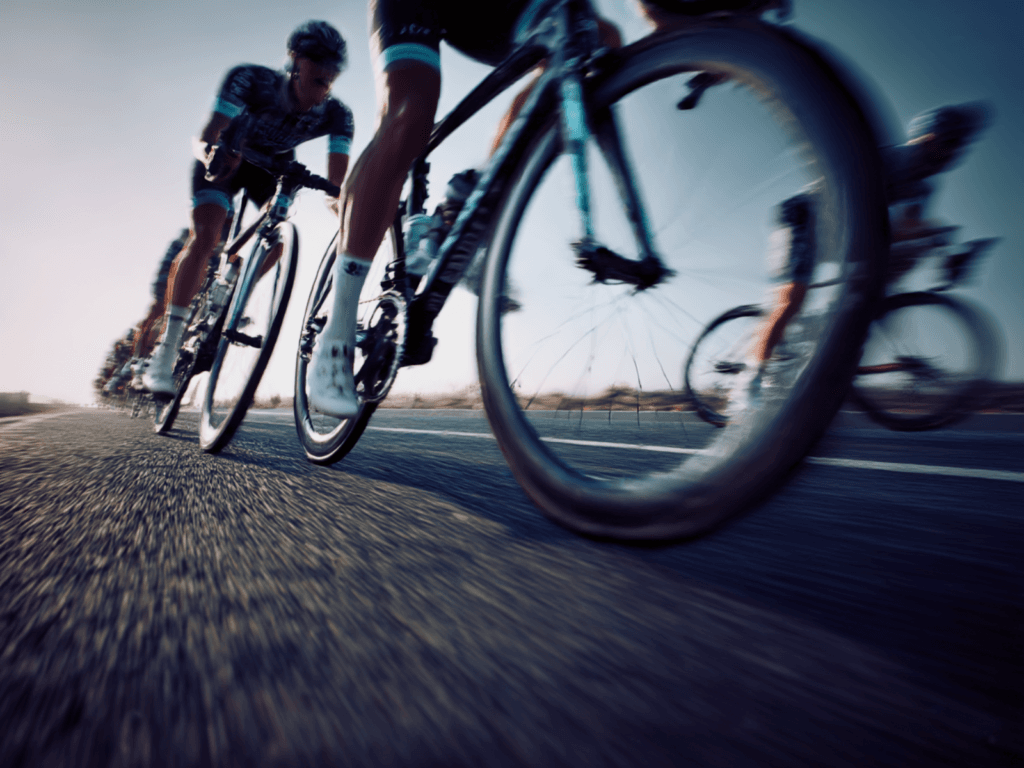 Professional cycling peloton in motion during a WorldTour race, captured with subtle motion blur and neutral tones
