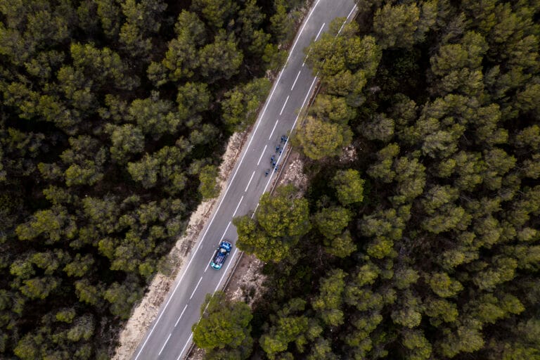 Bahrain Victorious riders during training ride with team car on forest road ahead of Amacx nutrition partnership 2026